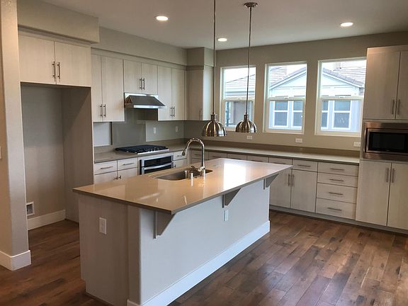 Kitchen with sizable island that can easily sit 4 for breakfast/lunch/dinner or gathering.
