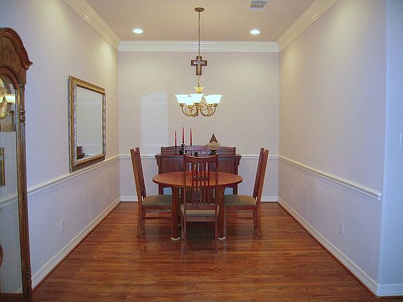 This is the dining area with hardwoods and custom moldings.
