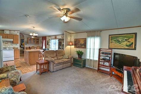 Living room looking into open concept kitchen