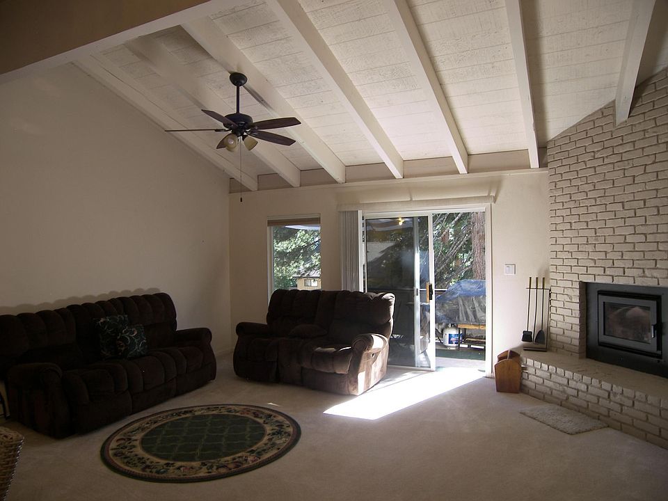 Living area, wood fireplace, carpet has been replaced with laminate wood.