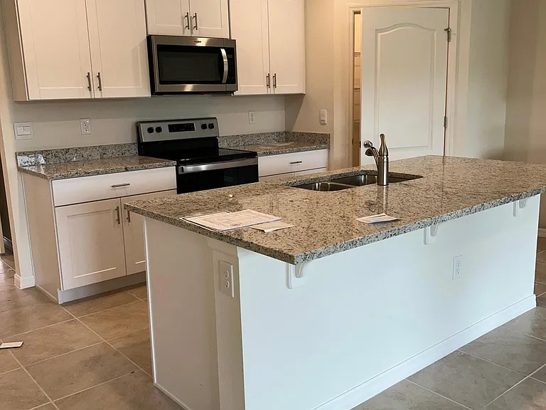 Granite countertops throughout the home. Open Floorplan with serene views of the backyard from the gourmet kitchen!