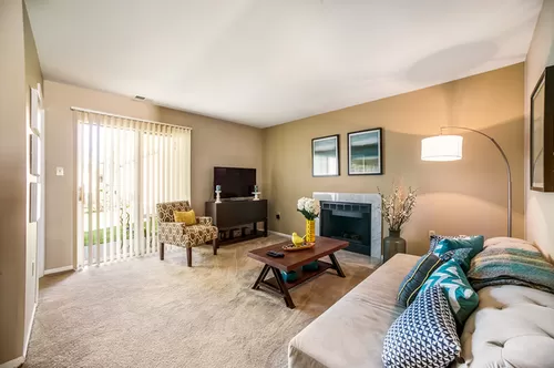 Spacious Livingroom with Woodburning Fireplace - Westchase Apartments