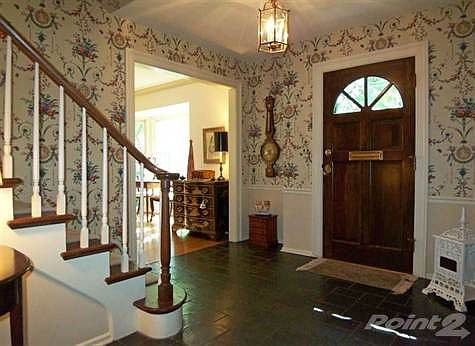 The stairway leading to the second-floor bedrooms and remodeled 2013 Powder Room are located in the Foyer as well.