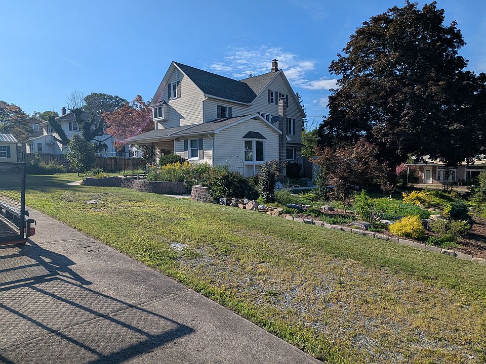 Concrete driveway and grassy driveway. The back of the house is essentially the front of the house - You enter into the kitchen.