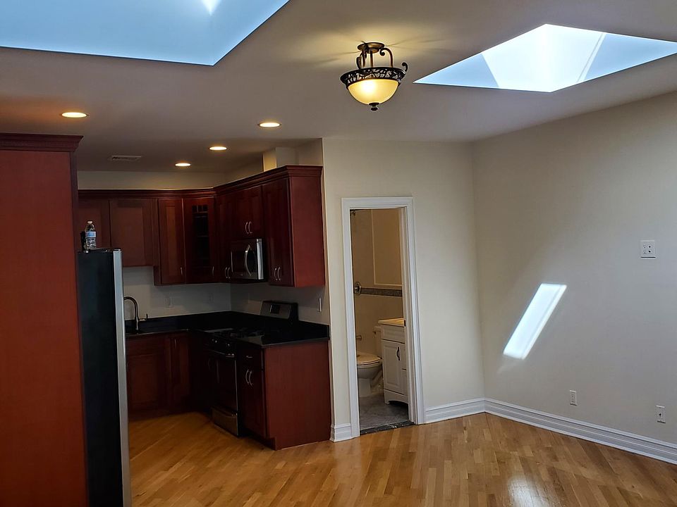 View of living room, kitchen and skylights