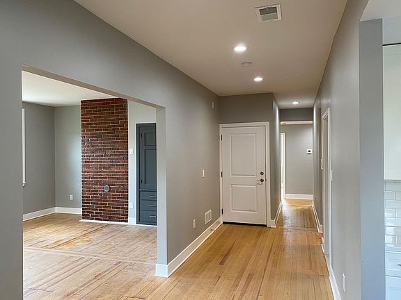 Hallway leading into kitchen, family room, and back to the bedrooms and bathrooms