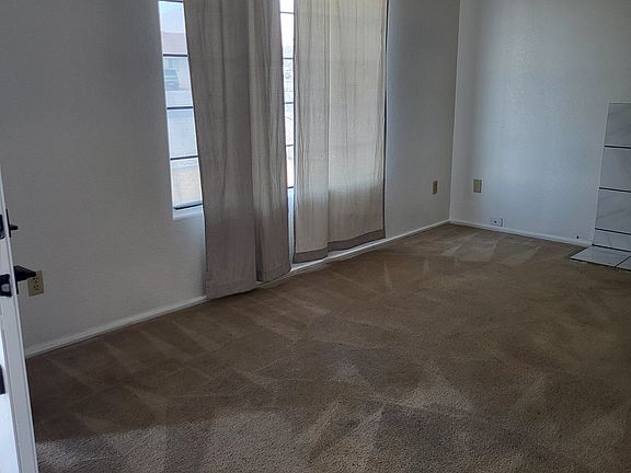 Living room. Drapes have been replaced with mini blinds. Sorry no new picture is available.