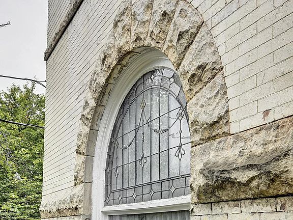 Front window with decorative glass lunette