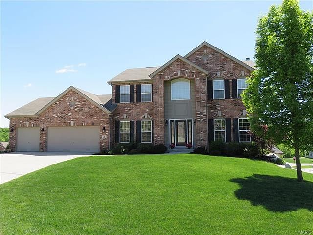 Estate style, brick front 2 story home with 3 car garage. Gorgeous green, well manicured lawn and landscaping.