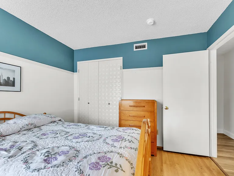 Bedroom with a full-size bed, one night stand with a lamp and a full dresser. One closet. All bedrooms have individual lock on the door.