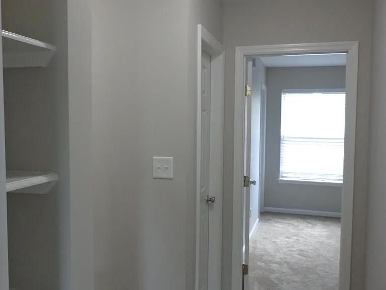 Upstairs Hallway with Built in Shelving and Walk-in Storage