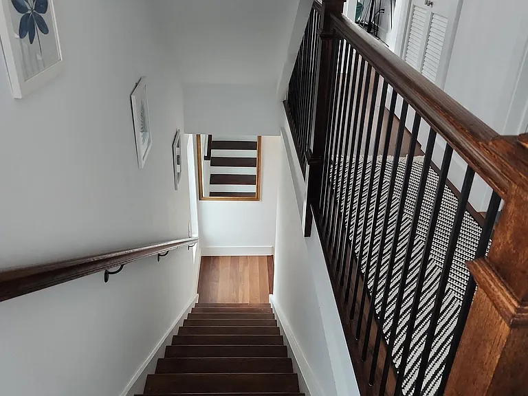 Stairs to bedrooms and roof top. Washer/dryer in hallway behind double doors.