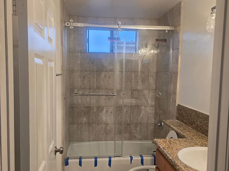 NEW GLASS SHOWER DOOR AND DESIGNER TILED SHOWER