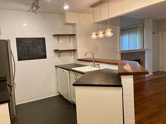 Recently renovated kitchen with soapstone counters, newer appliances and walnut woodwork.