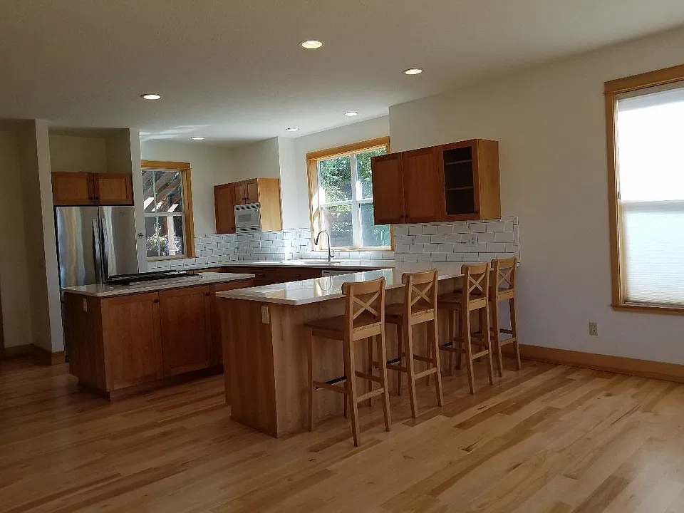 Stunning kitchen with expansive quartz countertops, stainless steel appliances, and eating bar