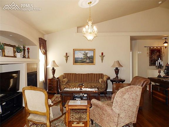 The formal dining also features a bayed window and hardwood floors