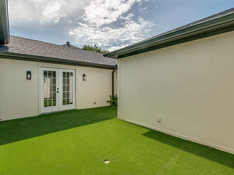 French doors leading to central courtyard from primary bedroom