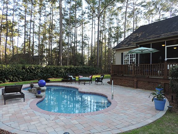 Stone patio surrounding pool