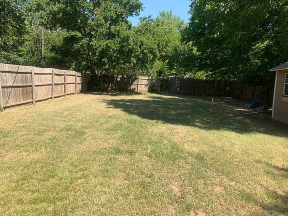 Beautiful yard completely surrounded with trees provides privacy and shade.