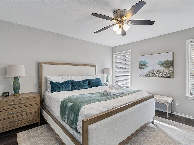 Primary Bedroom with King Sized Plush Bed, Bedside Chests with 3 Drawers with Lamps, Full Sized Dresser with Large Flat Screen Smart TV