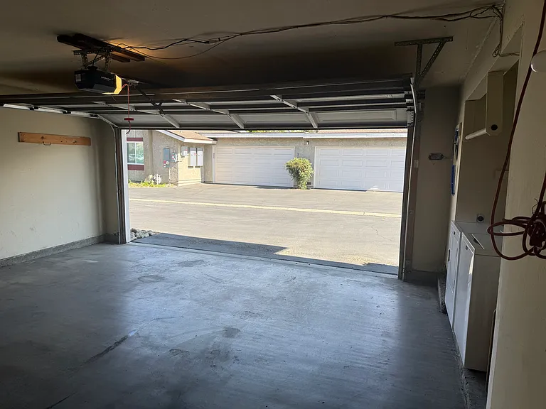 Two-car garage with washer/dryer and additional storage area. New wifi-enabled garage door opener.