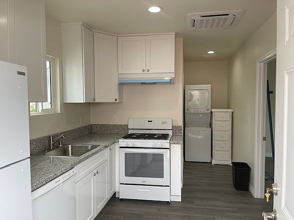 Full kitchen with a view of the laundry area that is all included