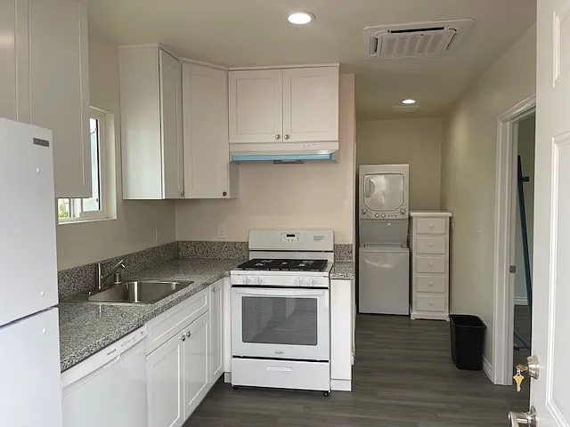 Full kitchen with a view of the laundry area that is all included