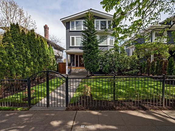 Nicely manicured front yard with gated entry.