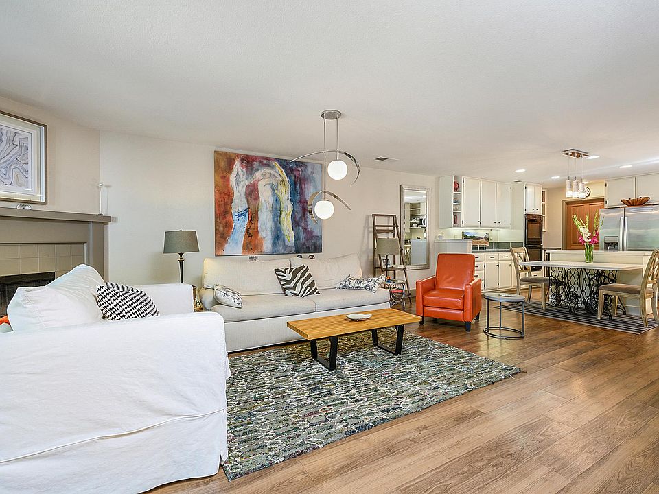 View of the living area opening up to the kitchen, with expansive French doors opening onto the gorgeous patio.
