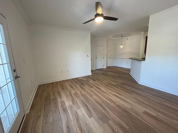 Living Room looking into Dining and Kitchen. French Doors going out to Deck.