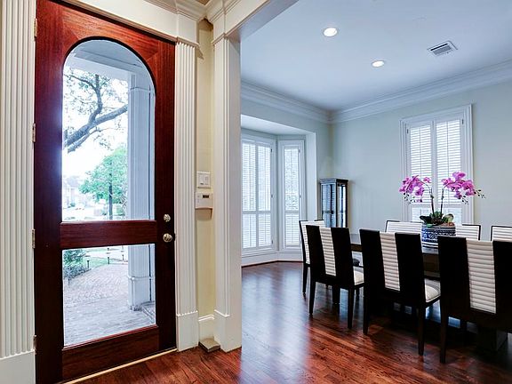 A beautiful wood and beveled glass door adorns the entry.