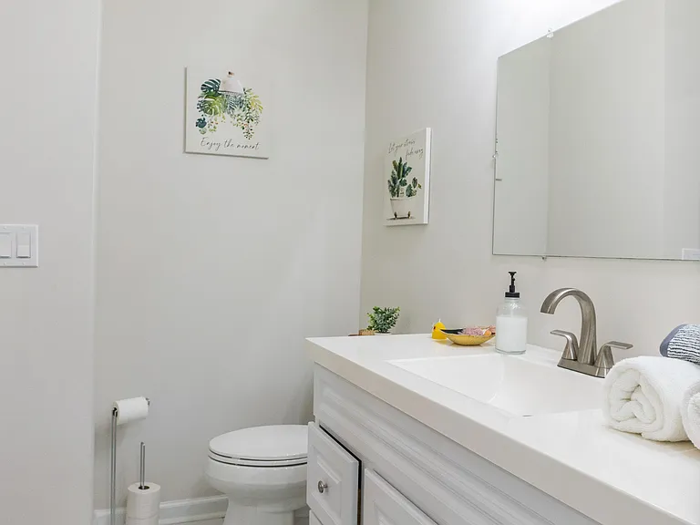 Well-appointed bathroom with a wide vanity, ample counter space, and a large mirror for everyday convenience.