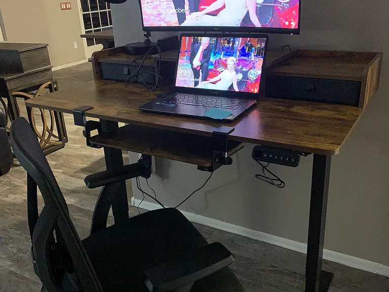 Adjustable desk with monitor attached