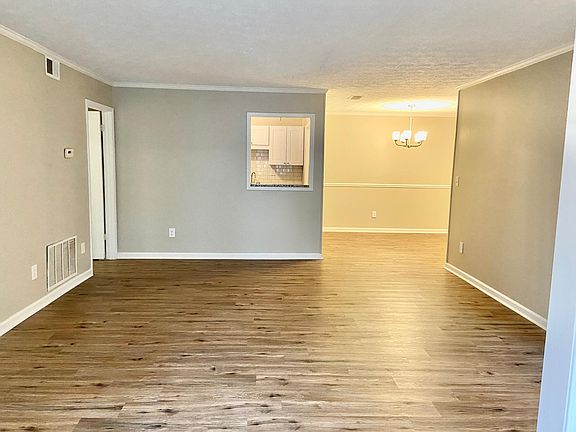 Large living room with view to kitchen and dining room