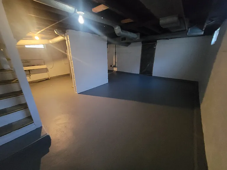 Newly painted walls & floor in BASEMENT with laundry hook-ups.