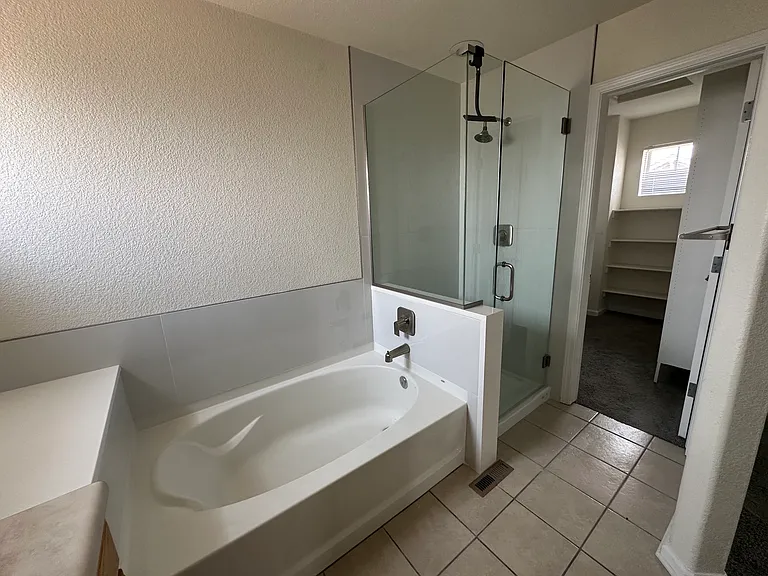 Bathtub and Glass Enclosed Shower