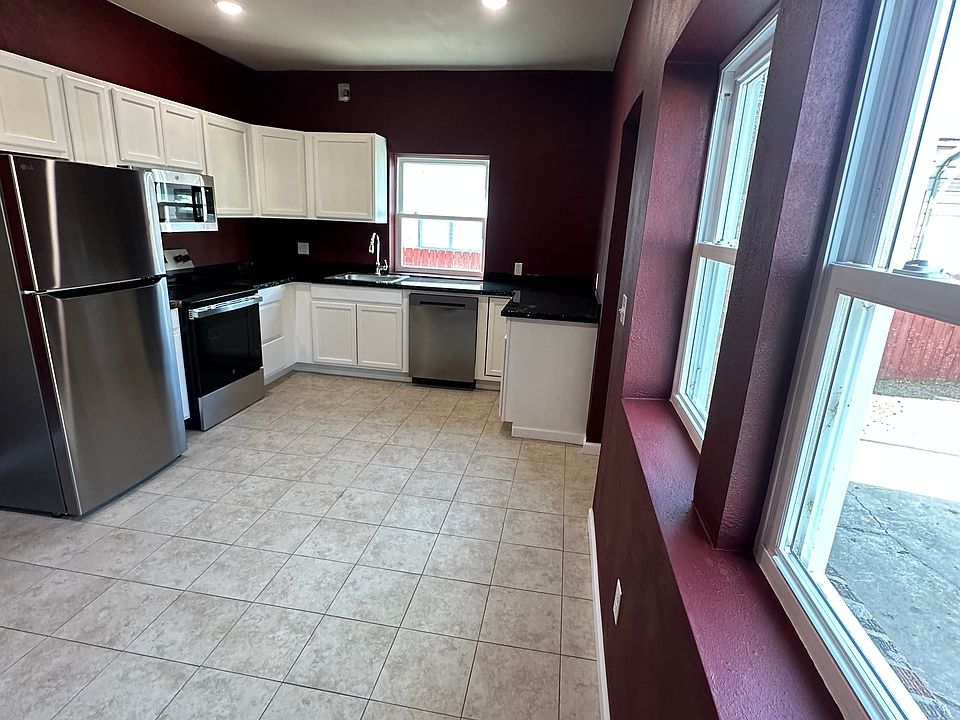 Kitchen dining room area large enough for a dining room table. The back door goes out to a partial fenced area.