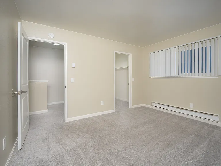 Step into a tranquil bedroom sanctuary with soft carpeting and serene ambiance.