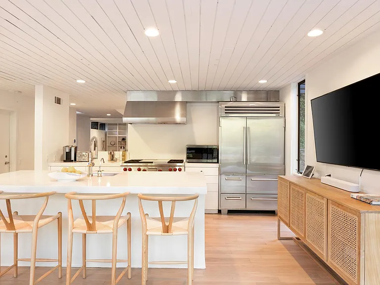 Counter seating, large flat screen TV overlooking the expansive grounds