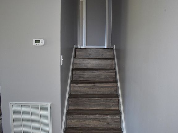 Stairs to upper level bedrooms/bathroom