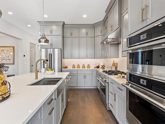 Stainless steel appliances, Kohler fixtures, cabinetry by Century
