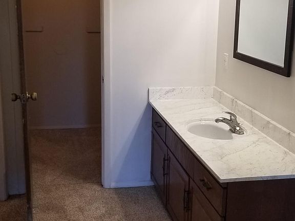 Master vanity with two walk-in closets. Shower and toilet are closed off for privacy.