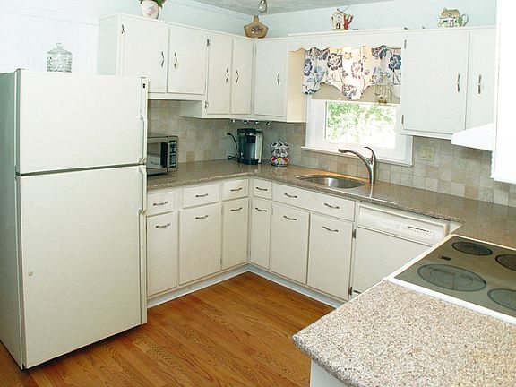 Kitchen work area with granite counters and hardwood floors