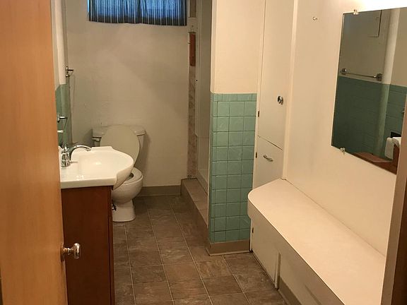 Bathroom with shower. Built in shelves on the cabinet on the right.