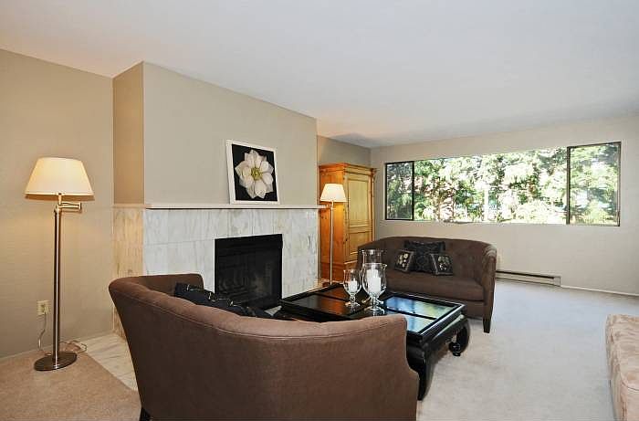 Living room w/ wood frpl