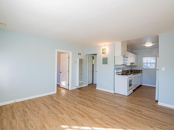 Another angle of the living room which shows you that it's open to the kitchen which leads to the outside entertainment area.