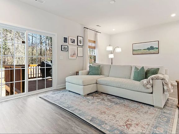 Back living rom opens to a sliding door to a deck