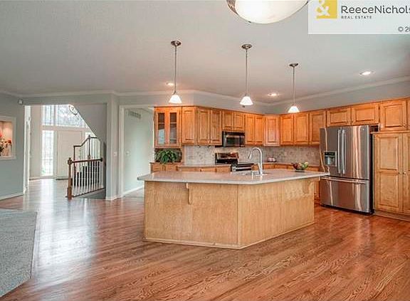 Refinished wood floor, silestone counter, stainless appliances, dbl oven new paint updated lights