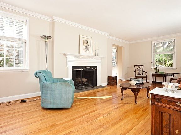 A view of the living room with wood-burning fireplace