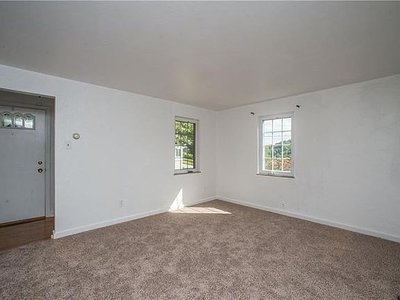 Freshly painted living room with new carpet!